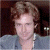 A pixelated image shows a person with light brown hair wearing a gray shirt against a dark background, next to green text reading 'Original Icons .com' on a solid green backdrop.