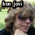 Pixelated image of a person with light brown hair and dark sunglasses, wearing a black jacket over a white shirt, with 'bon jovi' text in blocky font above the head.