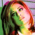 Pixelated close-up of a person with long dark hair and light skin, wearing green clothing against a gradient background.