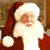 Static pixelated image of Santa Claus in red and white attire with a brown background.