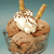A glass bowl of chocolate ice cream with whipped cream and two wafer sticks, displayed in a of four with one blank