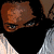 A person with dark hair and light skin wears a black mask covering the lower face, visible in four -aligned showing slight head position shifts