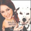 A woman with dark hair smiles while holding a Dalmatian dog, with partial text 'mike' overlaid on the image.