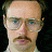 Pixelated image of a person with light skin, glasses, and mustache next to text reading 'your mom goes to college.'