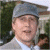 A pixelated image of a person wearing a gray cap and light-colored shirt, with green text reading 'Original Icons .com' on the right side.