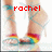 A pixelated image of a person's lower legs and feet wearing strappy high-heeled sandals with rainbow-colored straps, red text reading 'rachel' overlaid on the image.