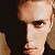 Pixelated image of a person's face on the left and green text reading 'Original Icons .com' on the right against a dark background.
