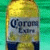 A 2x2 contact sheet of a Corona beer bottle and logo animation frames with pixelated details on a gray background.