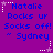 Purple background with blue text reading "Natalie Rocks ur Socks off! ' Sydney" surrounded by white and purple star outlines in a pattern