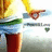 Pixelated figure in yellow top and blue pants points right with green arm, red shoes, white background, partial green and blue shapes.