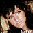 A 48x48 pixel animated buddy icon featuring a static portrait of a person with dark hair and light skin on the left, paired with colorful pixelated text reading "you you make you make me wanna la-la" across multiple frames against a black background.