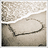A pixelated static image shows a light-colored, irregularly shaped object with dark edges against a textured background of beige and brown tones.