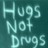 Pixelated teal background with light cyan text reading 'Hugs Not Drugs' in three lines.