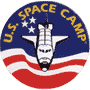 Circular U.S. Space Camp logo icon featuring a space shuttle against an American flag-inspired background with stars and stripes, yellow text arching around the top.