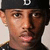 Two side-by-side pixelated portraits of young men with distinct facial features and clothing, one wearing a black cap with white lettering.