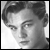 Black-and-white pixelated portrait of a person with short hair, visible facial features including eyes and nose, in a static single-frame icon format.