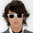 A pixelated image of a person with dark wavy hair wearing white sunglasses and a black choker, shown in two side-by-side frames.