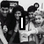 Black-and-white photo of two people with overlaid text 'I' and '1D', red vertical banner on right, grayscale background.