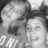 A grayscale pixelated image shows two side-by-side faces with visible text at the bottom, likely a digital icon or avatar.