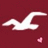 White seagull silhouette flies left to right against deep red background with small pink hearts floating below.