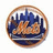 Circular icon with brown border containing pixelated cityscape with blue buildings and orange-brown structures on dark base.