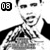 Black-and-white pixelated image of a person with short hair, wearing a dark jacket over a light shirt, making a thumbs-up gesture with both hands.