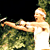 A 2x2 contact sheet of three animated frames showing a person with a white headband holding a tennis racket in various poses against green foliage background.