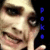 Pixelated close-up of a person's face with blue text on the right side, displayed as a static 50x50 buddy icon.
