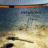 A static contact sheet of a 4-frame animation showing text fragments over a blue background with a small landscape image on the left, arranged in a 2x2 grid layout.