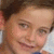 A child with brown hair and light skin smiles in a of four showing subtle facial expression changes