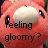 Pixelated image with red and pink background showing a face with large eyes and text reading 'Feeling gloomy?' in dark letters.