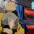 Six anime-style character arranged in a with text overlays; top-left shows two characters in yellow and blue, top-middle has a character with pink hair, top-right features a character with blonde hair and a black scarf, bottom-left displays two characters with orange background, bottom-middle shows a character with white hair at a keyboard, bottom-right has a character with gray hair