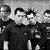 A 50x50 pixel animated contact sheet showing two frames of a grayscale image with four individuals in dark clothing, displayed side-by-side on a gray background.