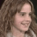 A four- shows a person with long brown hair in sequential facial expressions from smiling to neutral, wearing a light-colored top against dark background
