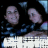 Two people in dark clothing with blue patterns pose together; text below reads "LORELA AND PORT" in blue and white.