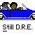 Blue convertible car with two brown-skinned figures in front seats, white accents on wheels and roof, gray background, text "Still D.R.E." below.