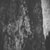 Grayscale pixelated image of a figure with indistinct features against a dark background, with a bright vertical strip on the right edge.