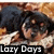 Pixelated image of a person with dark hair and light skin resting their head on a white surface, with text reading 'Lazy Boys' at the bottom.