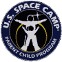Circular blue and black logo with white stick figures, yellow rings, and text reading "U.S. SPACE CAMP" and "PARENT CHILD PROGRAM" on a gray background.