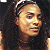 A 50x50 pixel animated buddy icon featuring a side-profile of a person with long dark hair and a headband, alongside green text reading "Original Icons .com" on a solid background.