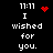 Black background with white pixelated text reading "I wished for you." and time "11:11" above, accompanied by red pixelated heart and starburst icons.