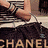Four- of Chanel-themed fashion items: a hand holding a striped bag, pink fabric with black bows, silver jewelry on gray background, and pearls with CC logo necklace