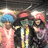 Three figures in a group pose with one holding an umbrella, rendered in low-resolution pixelated style.