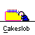 Yellow rectangular cake with blue and orange sprinkles, a blue-clad figure leaning over it, and "Cakeslob" text below.