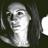 Pixelated grayscale image of a person's face with long hair, displayed as a static buddy icon on dark background.