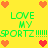 Yellow background with green text reading "LOVE MY SPORTZ!!!!!!" and pixelated hearts in orange, red, and pink arranged around the text.
