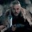 Pixelated image of a person with light hair holding a glowing sword-like object against a dark background.