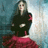 A pixelated image of a person in a black top and red skirt standing against a blurred background with text on the right.