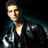 Pixelated image of a person in a black leather jacket with text reading "JUST A ROLLING STONE" and "DONNIE KLANG" in blue neon-style lettering.