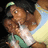Pixelated image of two figures in a close embrace, one wearing green and white clothing with dark hair, the other with light brown hair against a gradient background.